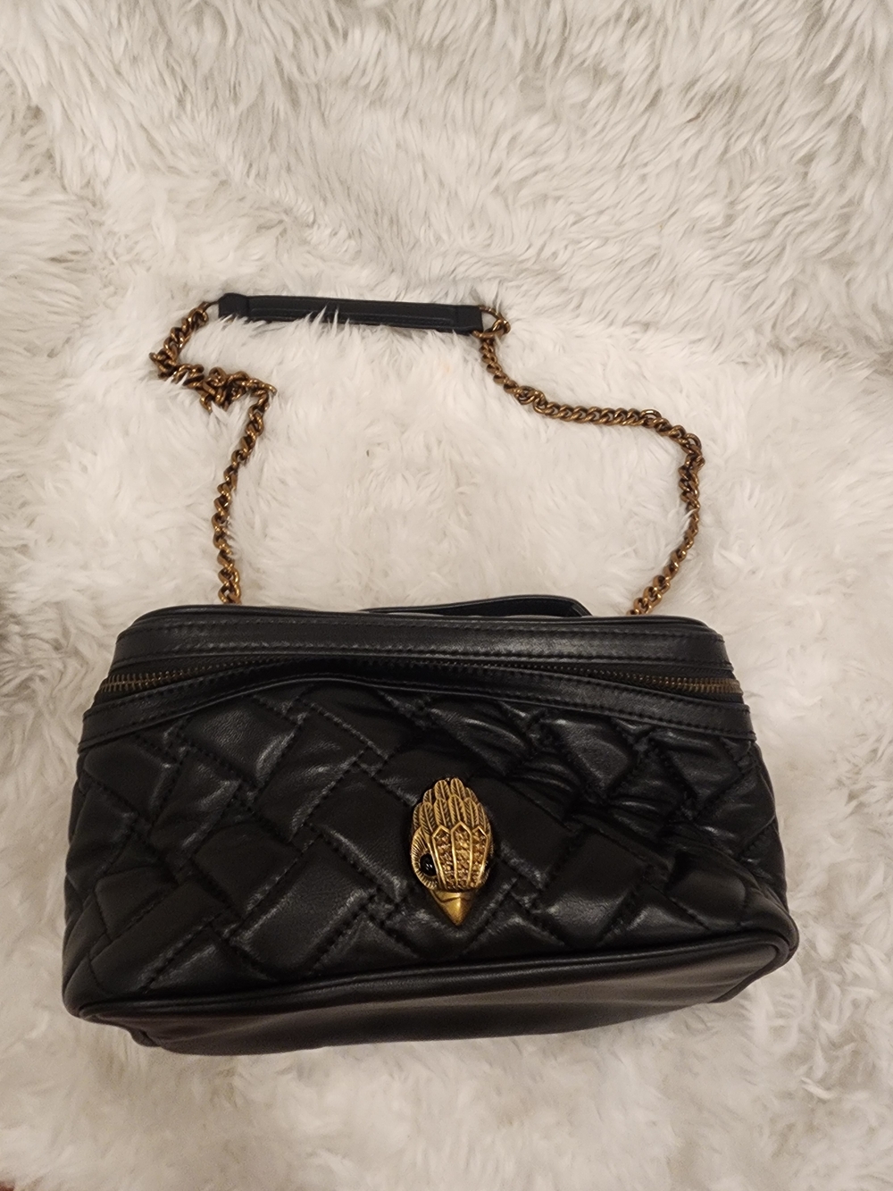 Black Quilted Crossbody Bag with Gold Chain and Decorative Emblem